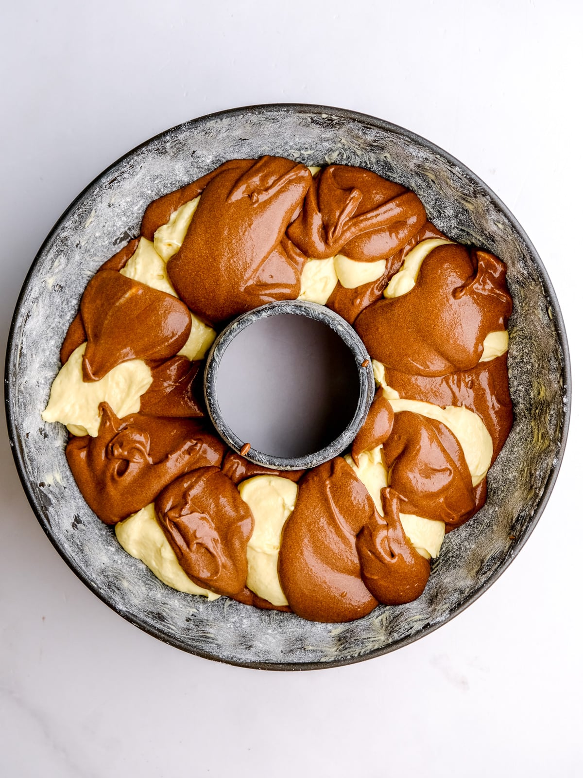 Image shows step 5 of how to make a marble bundt cake.