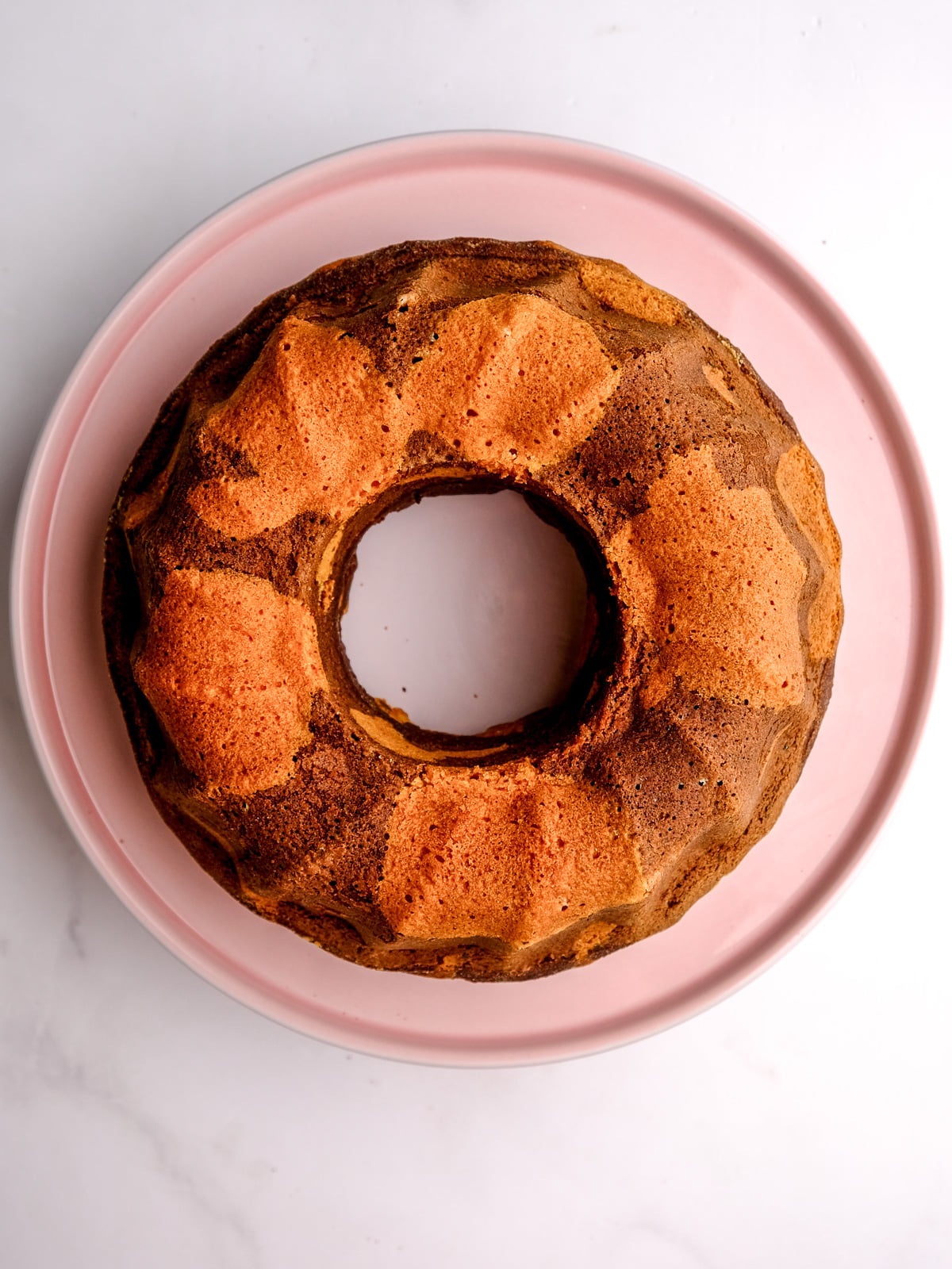 Image shows step 6 of how to make a marble bundt cake.