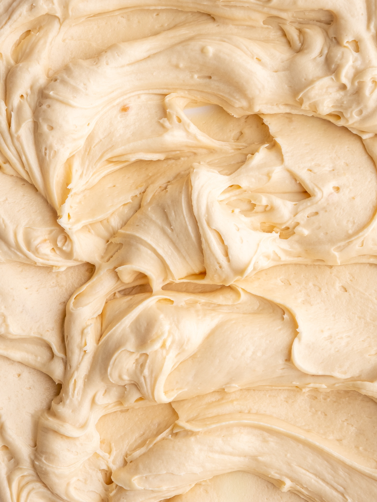 Image shows step 4 of how to make caramel cream cheese frosting for this peppermint crisp cupcake recipe.
