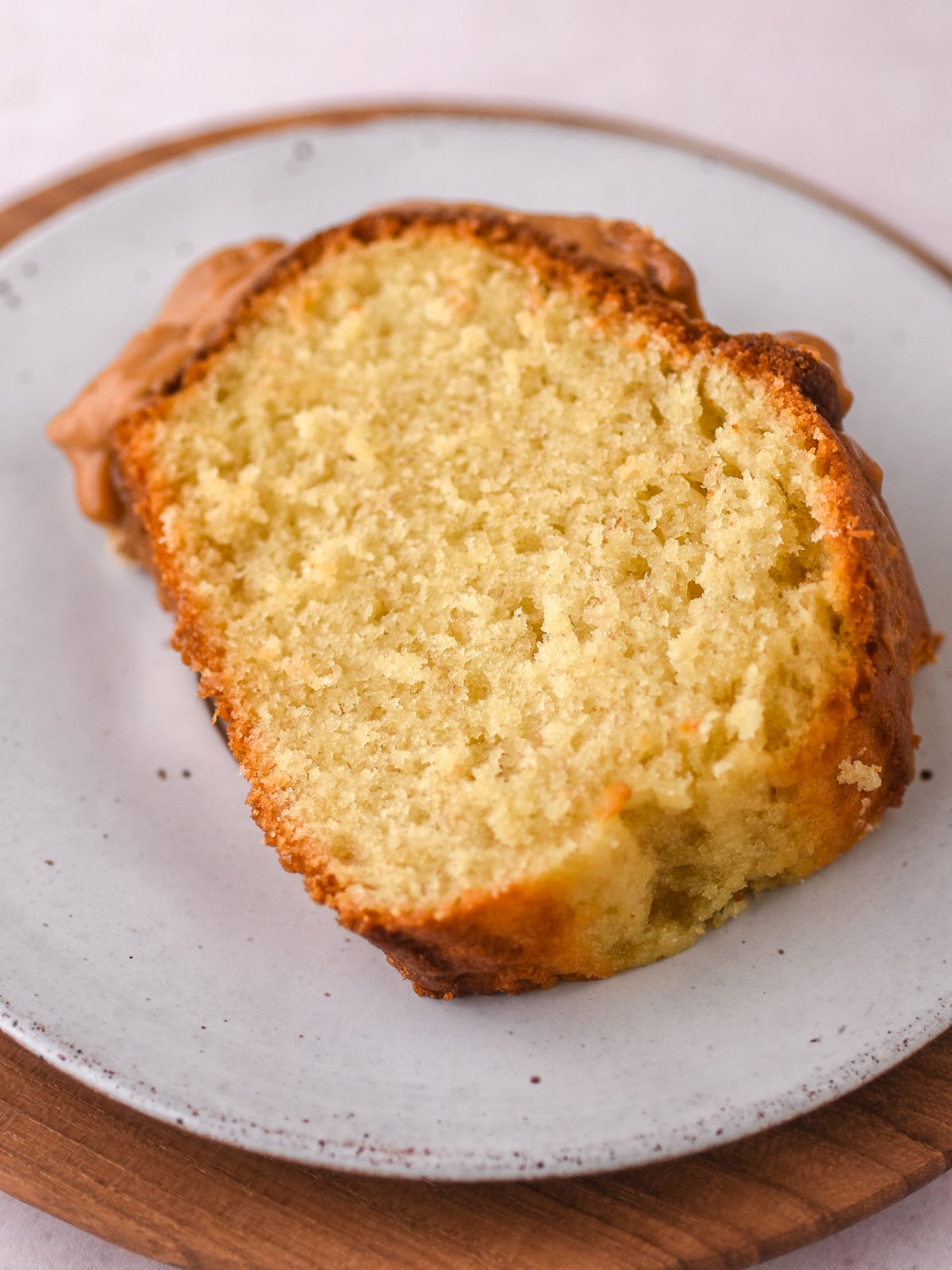 Image shows a slice of Banana Bundt Cake with Sour Cream. You can see the perfect fluffy texture of the cake.