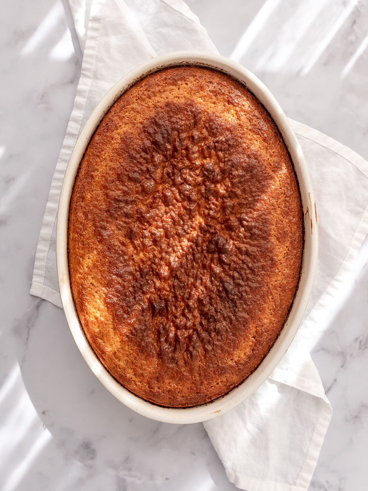 Image shows step 4 of how to make a malva pudding.