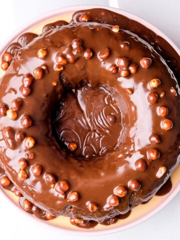 Chocolate nut cake shown from about, it has been baked in a circular bundt cake pan.