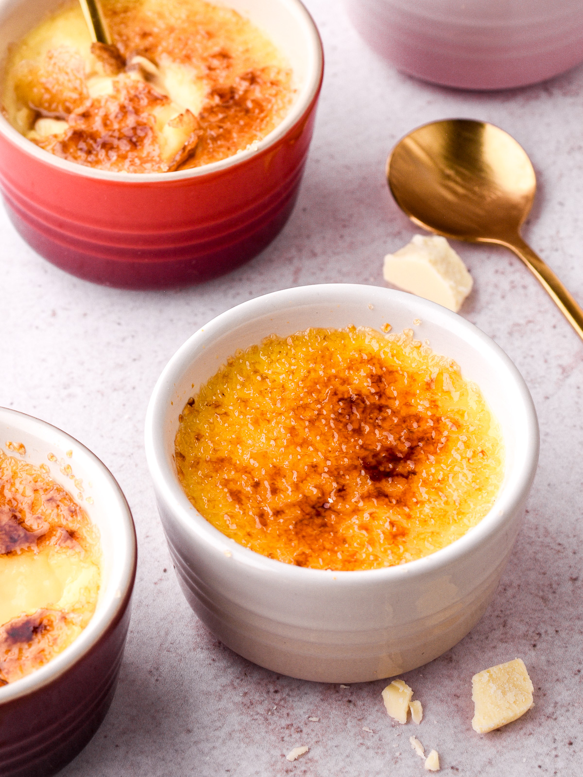 Image showing small ramekins filled with creme brulee, the tops have been torched to make the sugar crust.