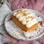 Mini carrot cake loaf with cream cheese icing shown on a plate