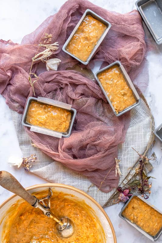 Mini Carrot Cake Loaves are shown in the tins before baking from above. 