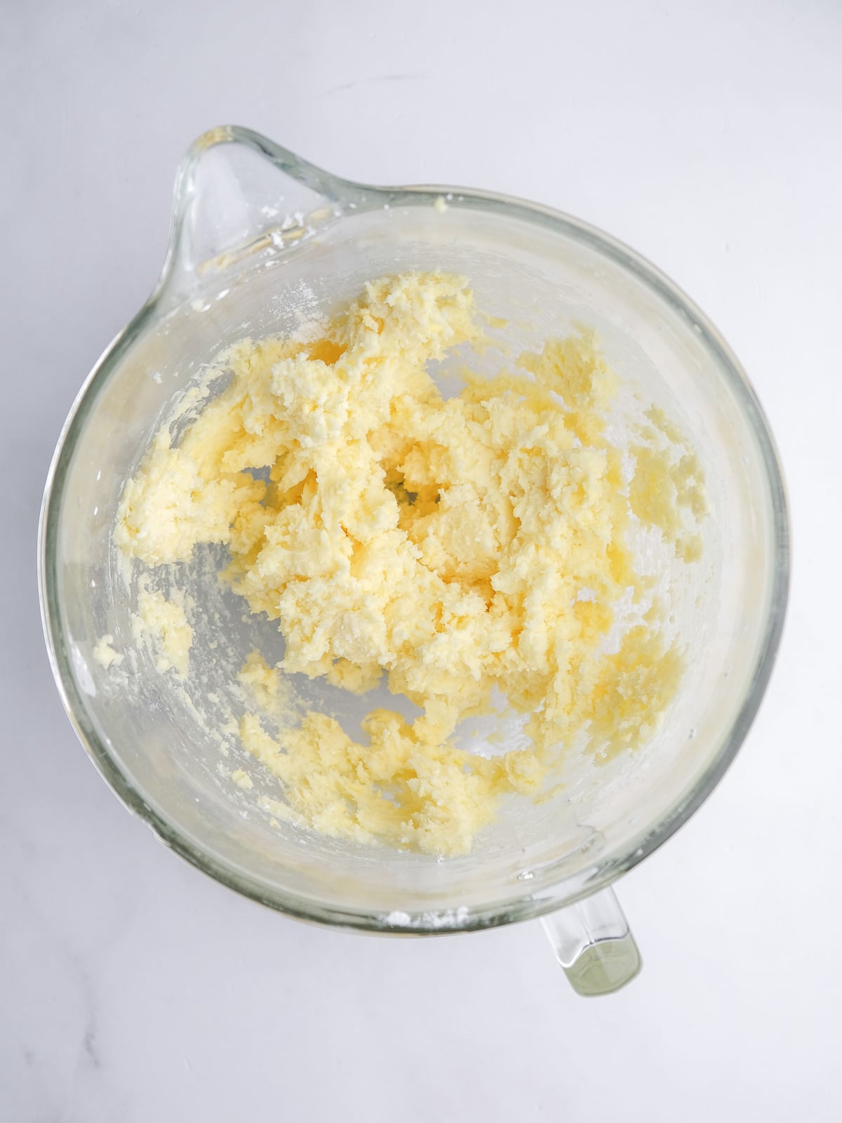 Image shows step 2 of how to make cream cheese frosting for mini carrot cakes.