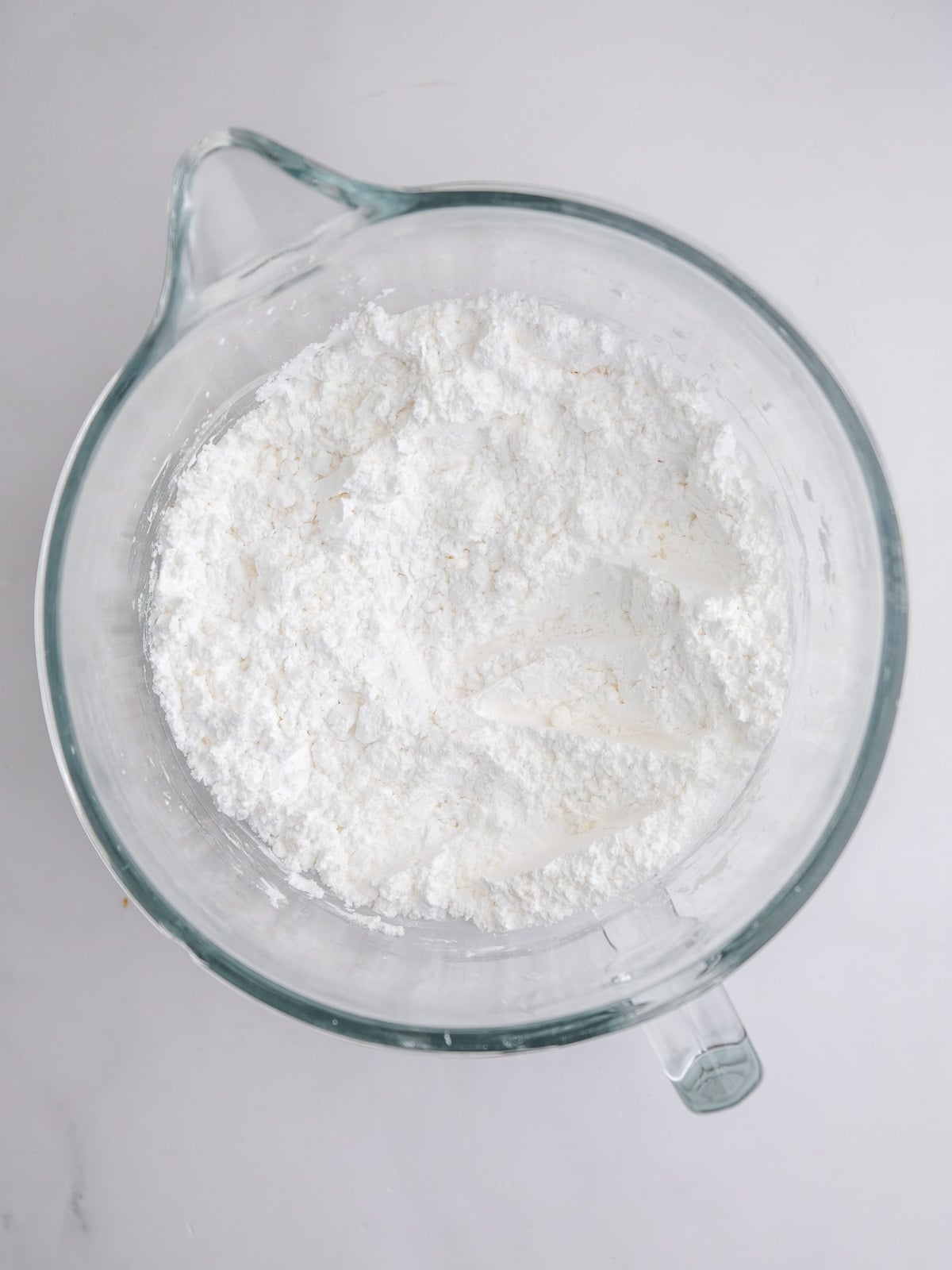 Image shows step 1 of how to make cream cheese frosting for mini carrot cakes.