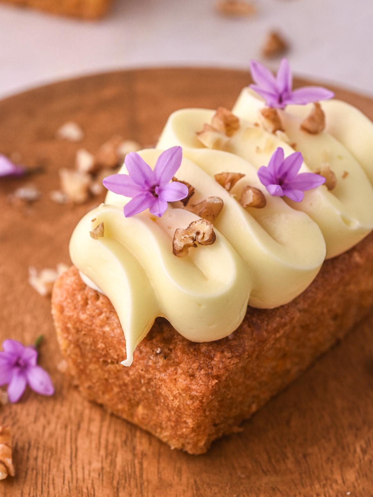 Mini carrot cake loaf cake shown from a lightly higher angel you can see the perfect texture of the cream cheese frosting.
