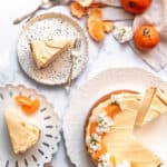 Vanilla cake with citrus caramel frosting shown from above next to citrus fruit
