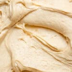 Peanut Butter Cream Cheese Frosting shown swirled on a surface so you can see the creamy texture.