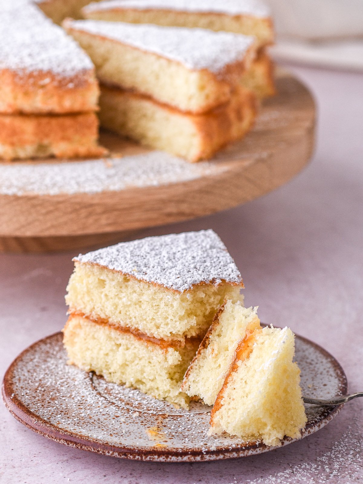 Image shows a slice of cake with a fork through it, you can clearly see the crisp crust and fluffy interior.