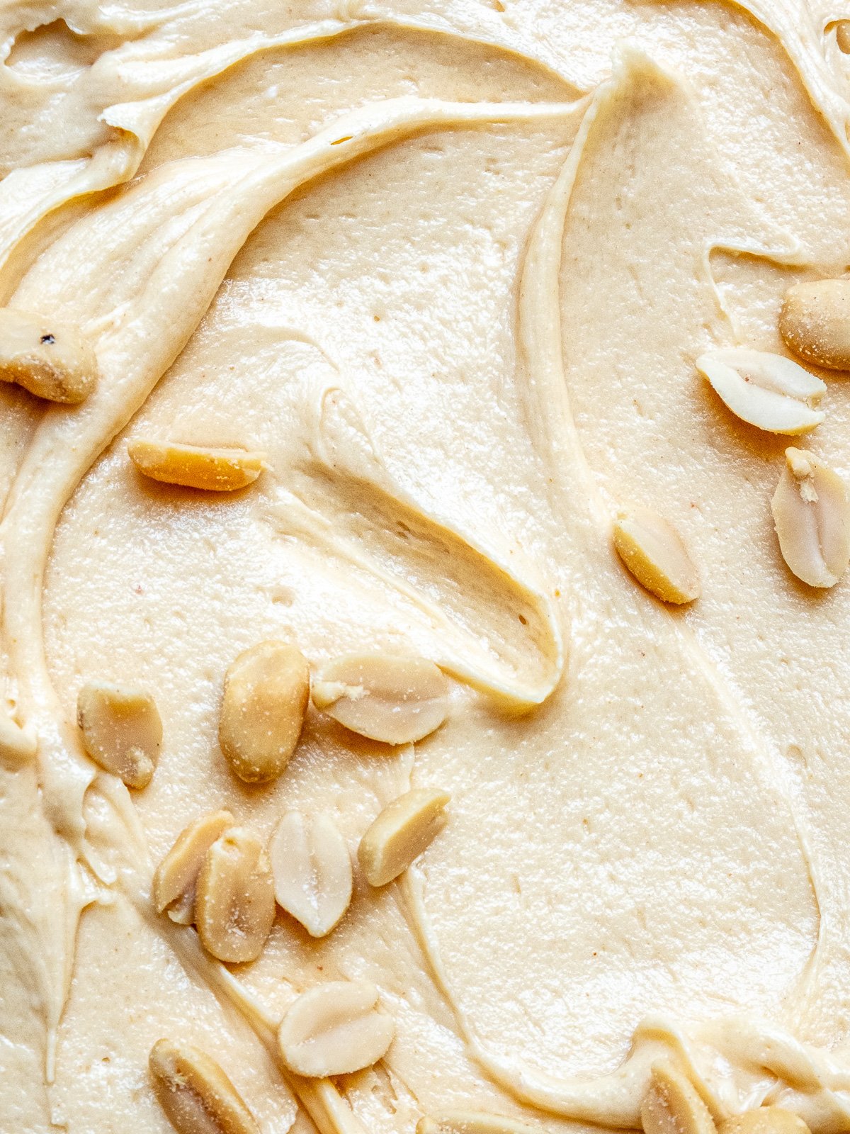 Image showing the frosting swirled and sprinkled with roasted peanuts.