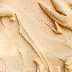 Coffee Buttercream shown swirled on a flat surface so that you can see the texture.