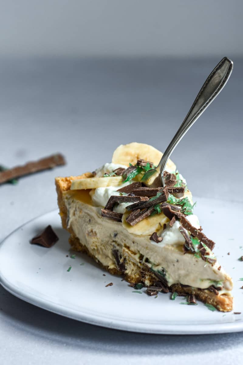 A slice of Peppermint Crisp Tart with a fork in it