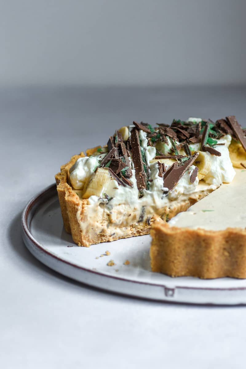 Peppermint Crisp Tart shown on a plate with a slice missing.