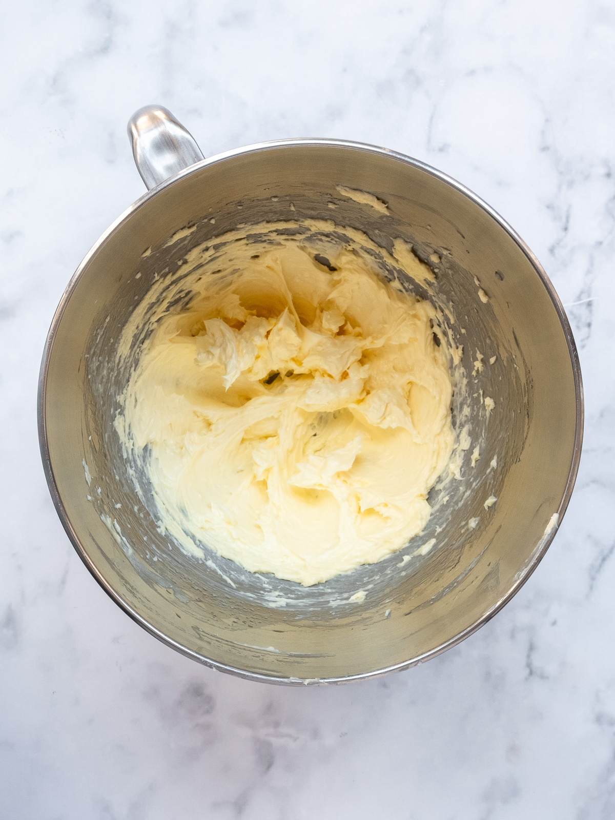 Image shows step 1 of how to make apple and blackberry crumble: creaming the oil, butter, and sugar.