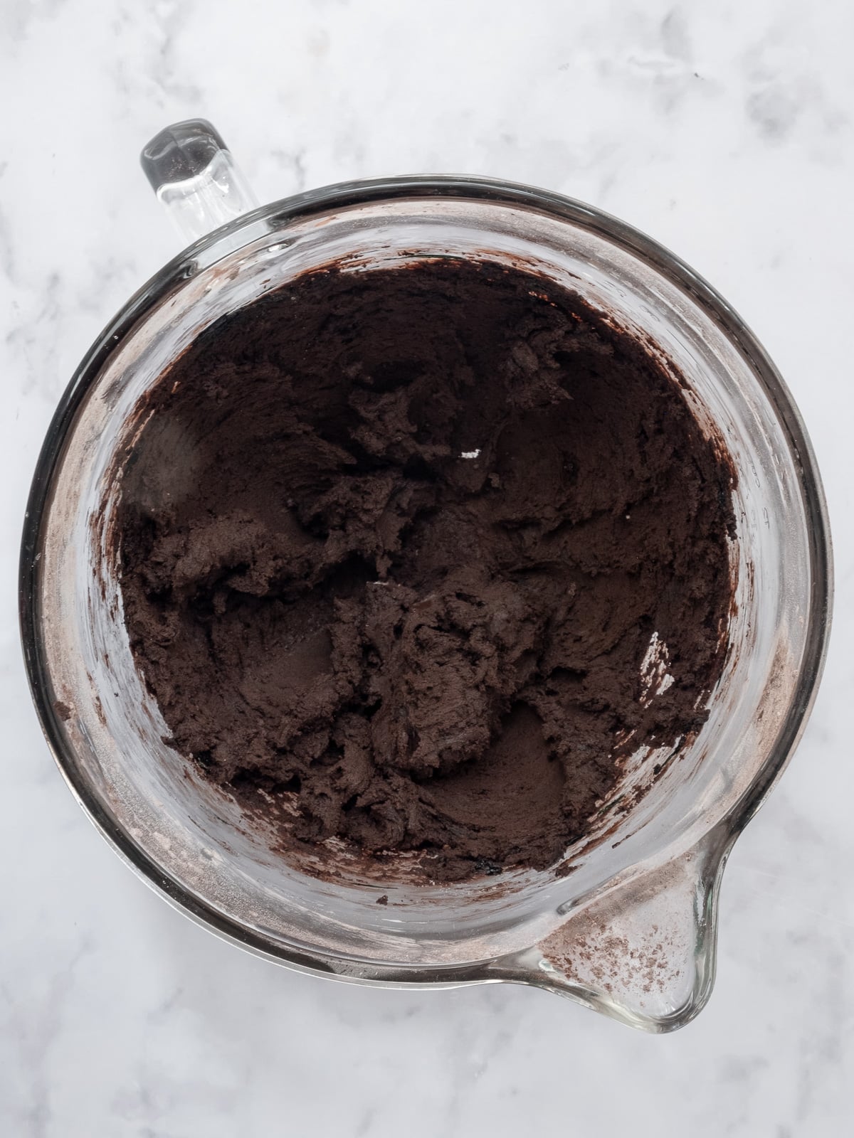 Image shows step 3 of how to make black buttercream frosting.