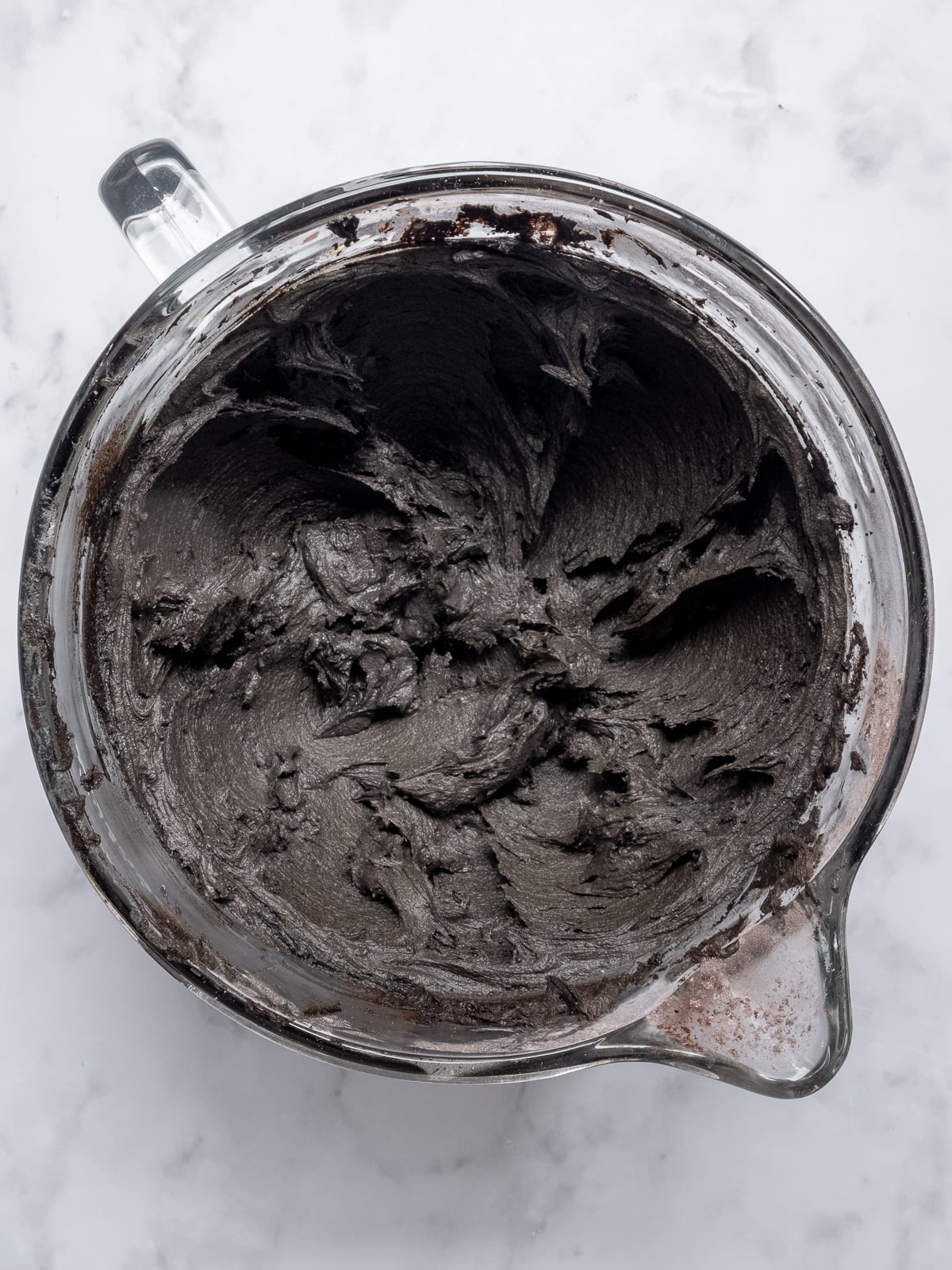 Image shows step 4 of how to make black buttercream frosting.