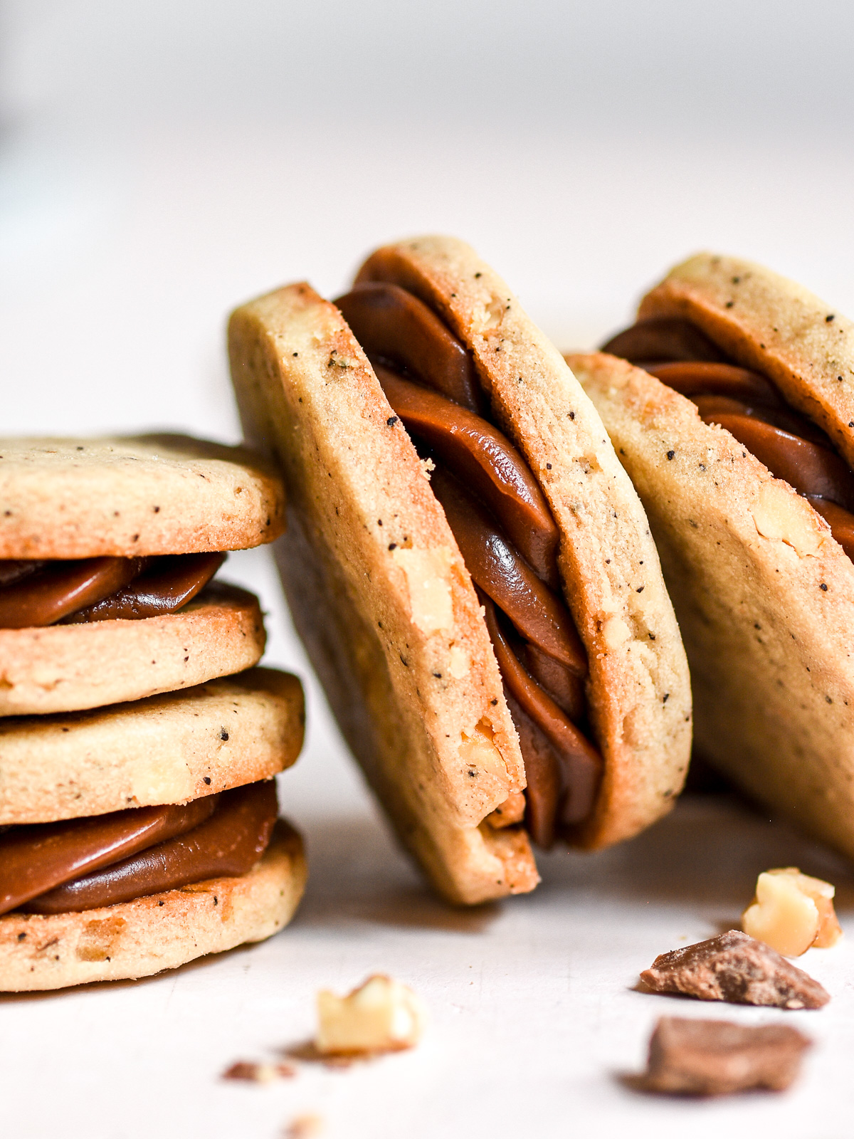 Coffee and Chocolate Ganache Sandwich Cookies shown up close so that you can see the coffee chocolate filling.