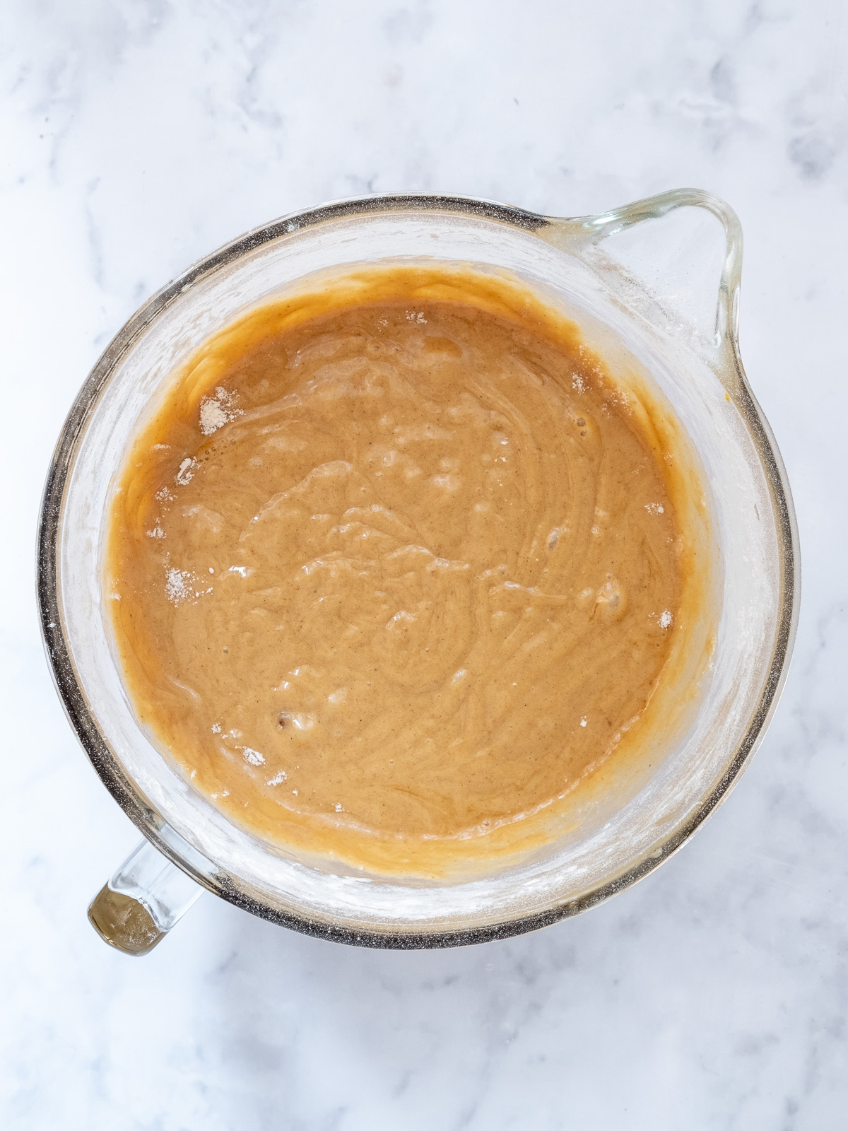 Image shows step 2 of how to make a pumpkin and carrot cake.