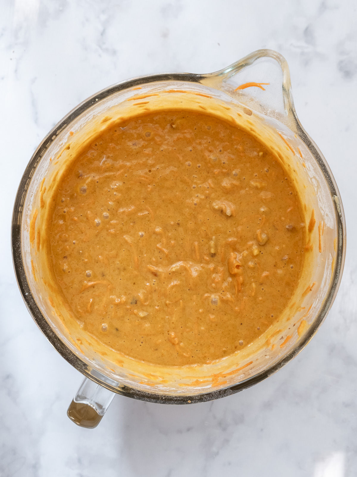 Image shows step 3 of how to make a pumpkin and carrot cake.