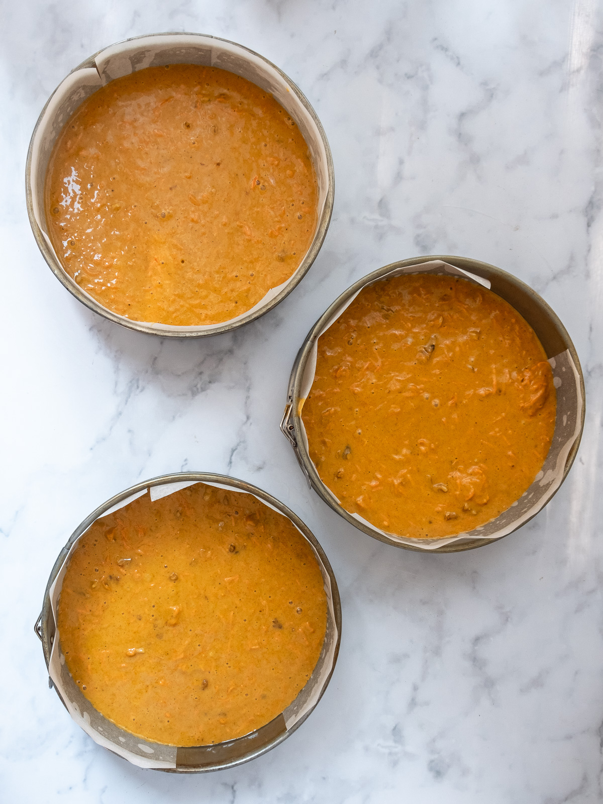 Image shows step 4 of how to make a pumpkin and carrot cake.