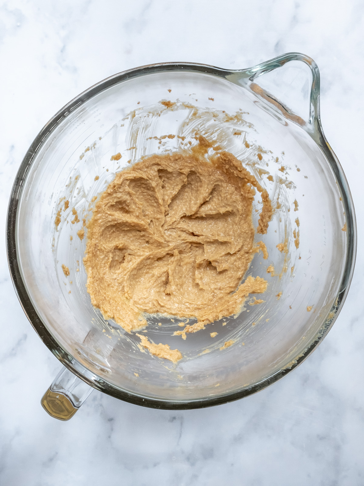 Image shows step 1 of how to make brown sugar cream cheese frosting for a pumpkin and carrot cake.