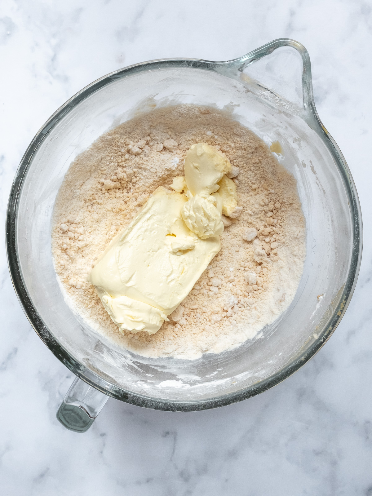 Image shows step 2 of how to make brown sugar cream cheese frosting for a pumpkin and carrot cake.