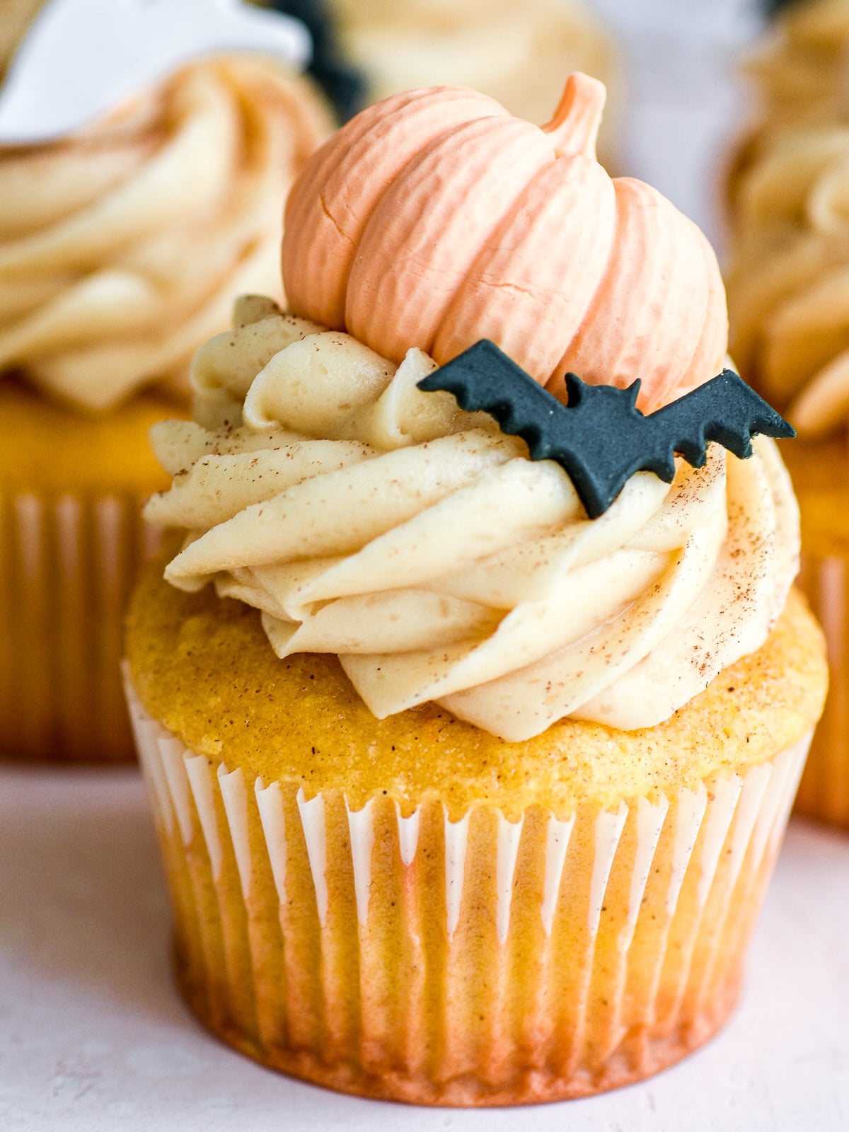 Image shows step 4 of how to make brown sugar cream cheese frosting for pumpkin Halloween cupcakes.