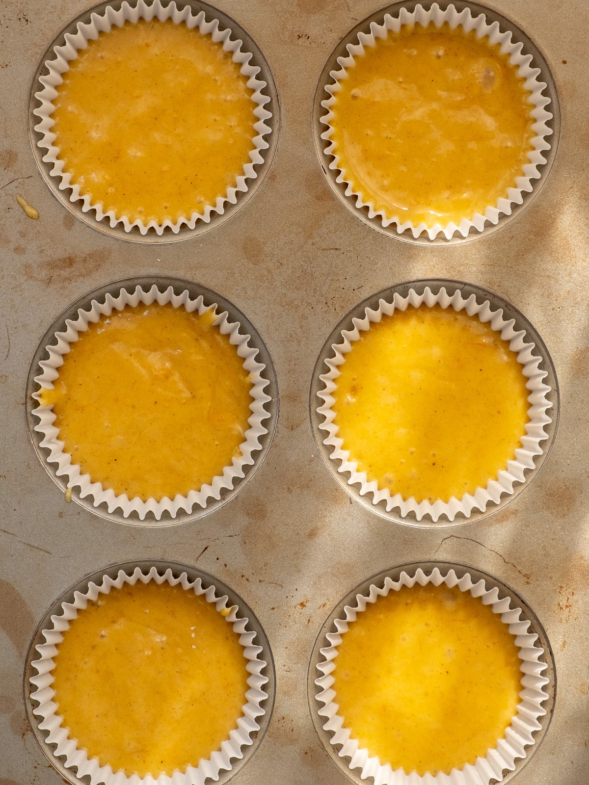 Image shows step 4 of how to make pumpkin cupcakes for Halloween.