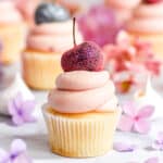 Cherry Frosting shown on a mini vanilla cupcake with a glitter cherry