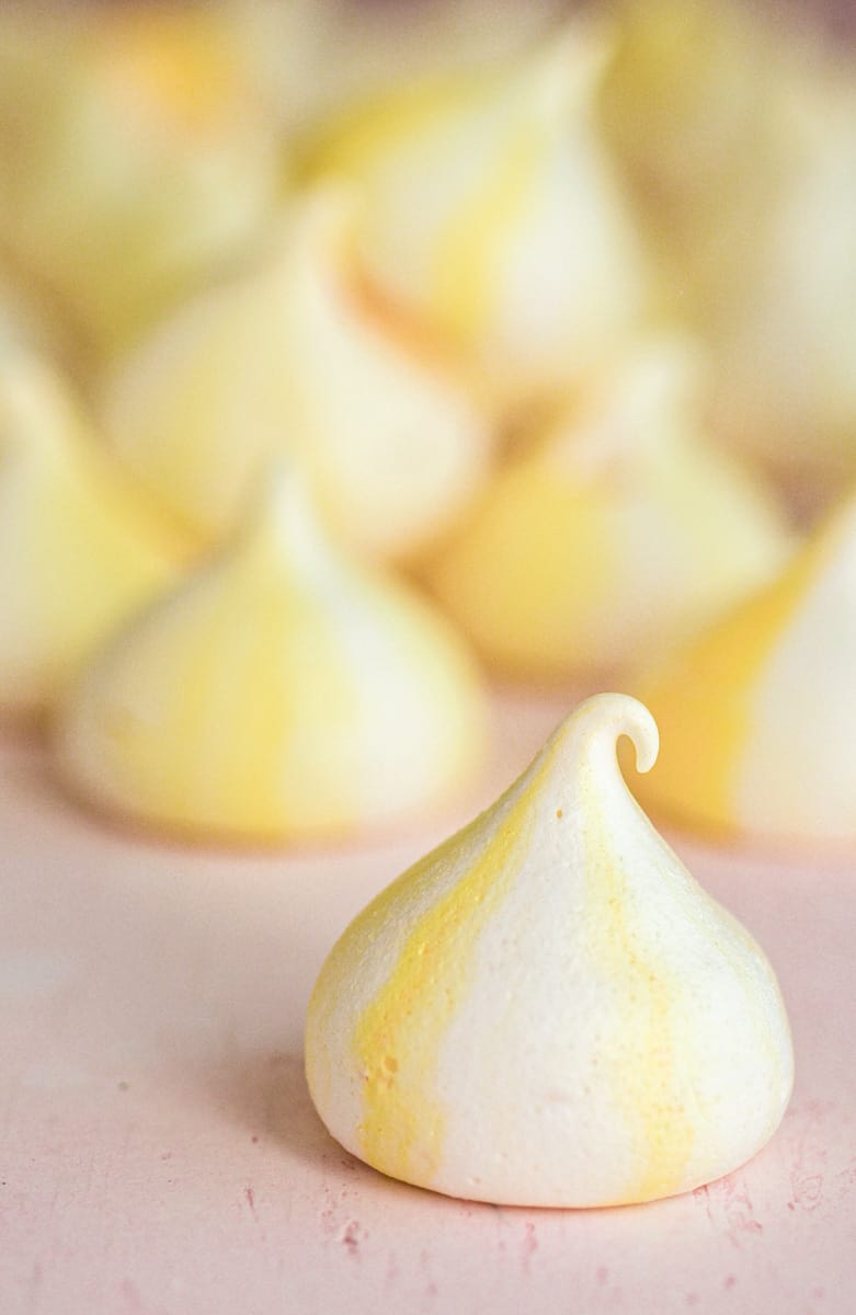 Lemon Meringues shown on a counter top with one close up.