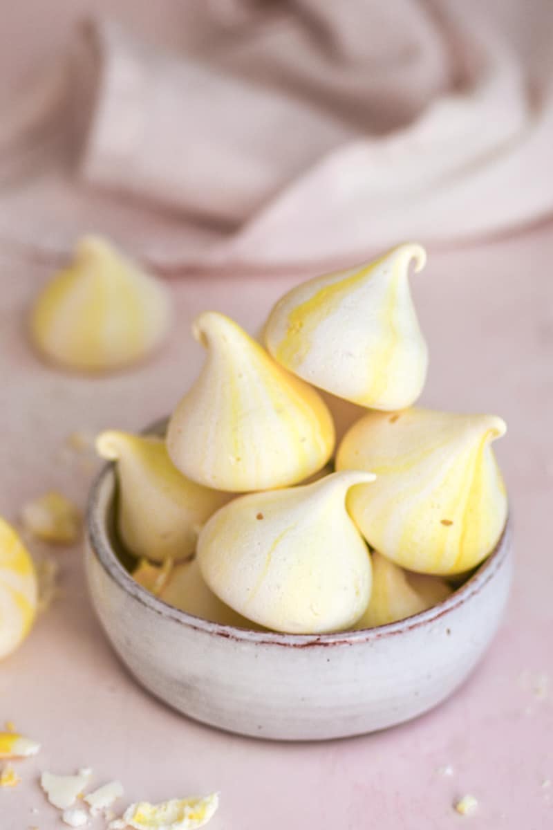 Lemon Meringues shown in a small bowl on a counter top.