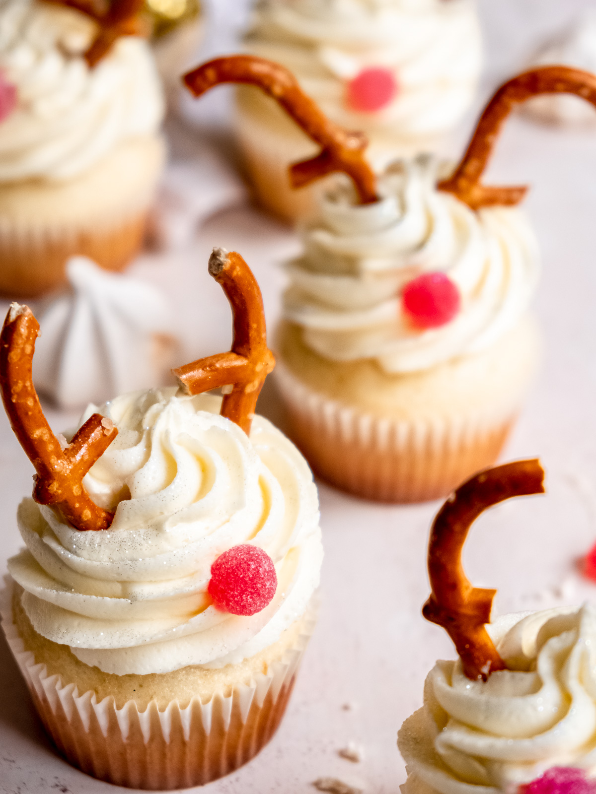 Vanilla reindeer cupcakes shown after decorating, this image shows the different shaped pretzels for antlers.