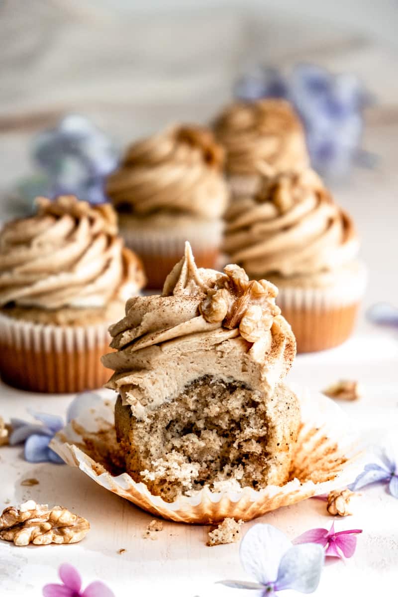 Coffee and Walnut Cupcake shown up close with a bite taken out of it.