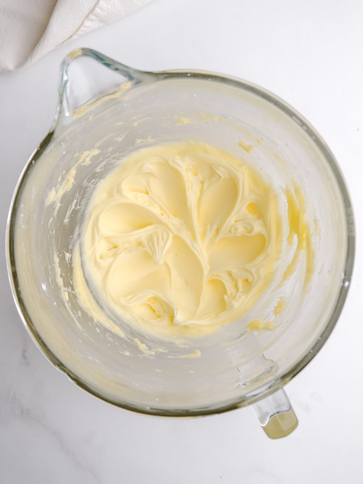 Image shows step 2 of how to make the cream cheese frosting.