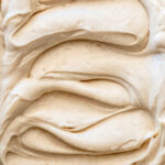 Image shows Cinnamon Cream Cheese Frosting from up close so you can see the smooth texture of the frosting.