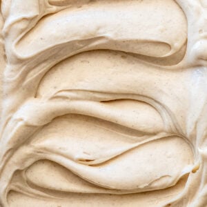 Image shows Cinnamon Cream Cheese Frosting from up close so you can see the smooth texture of the frosting.
