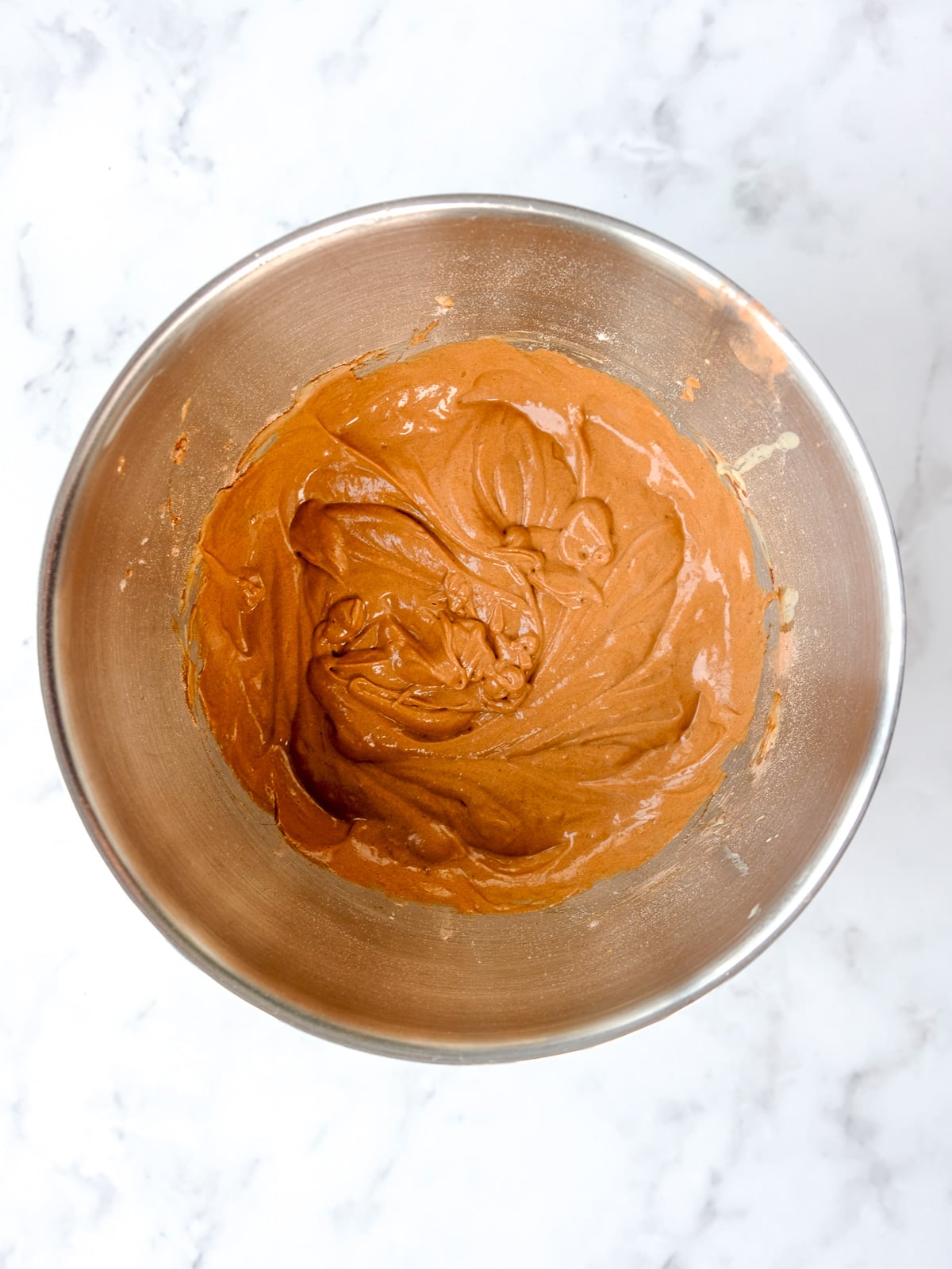 Image shows step 4 of how to make the moist chocolate cake.