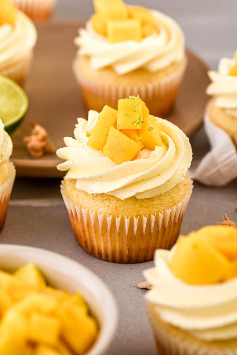 Mango Cupcakes shown on a grey kitchen counter.