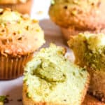 Pistachio muffins shown on a kitchen counter.