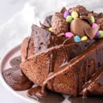 Easter Bundt Cake shown from the side on a cake plate with chocolate sauce dripping down the cake.