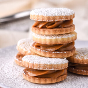 Dulce de Leche Cookies shown stacked on top of each other on a small plate.