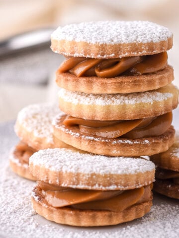 Dulce de Leche Cookies shown stacked on top of each other on a small plate.