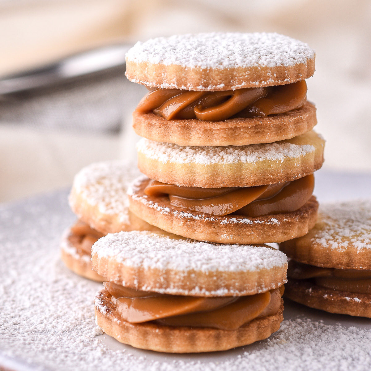 Dulce de Leche Cookies shown stacked on top of each other on a small plate.