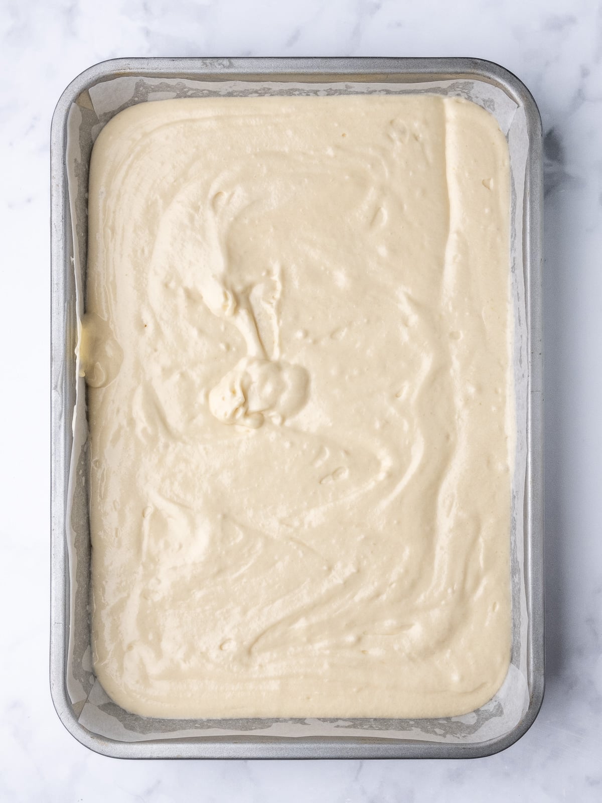 Image shows step 4 of how to make a vanilla tray bake.