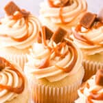 Caramel filled cupcakes shown on a kitchen counter