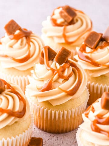 Caramel filled cupcakes shown on a kitchen counter