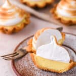 Mini Lemon Meringue Tarts shown on a kitchen counter