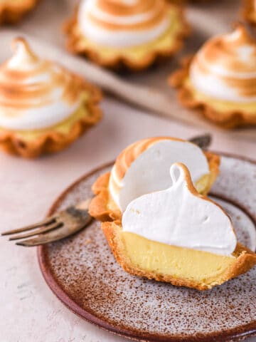 Mini Lemon Meringue Tarts shown on a kitchen counter